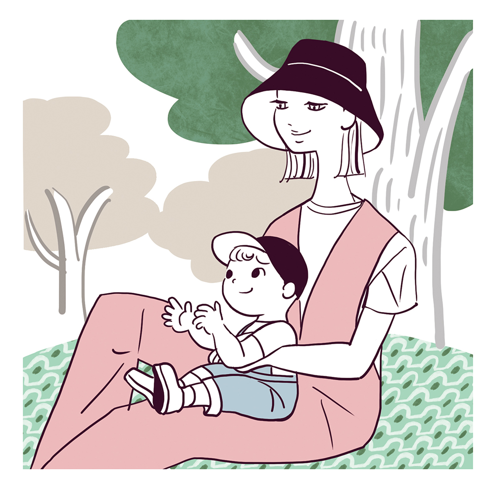 mother holding child, sitting in park